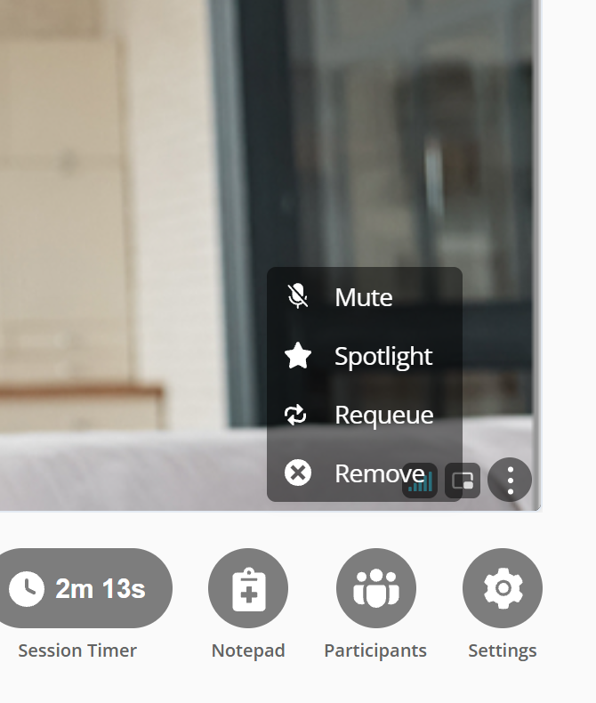 A dark menu open over the lower corner of a video tile, listing Mute with a crossed out microphone, Spotlight with a star, Requeue with a circular arrow, and Remove with a cross. The three dot button that opened it sits at the edge of the tile beside the menu. Below the tile are the Session Timer, Notepad, Participants and Settings controls.
