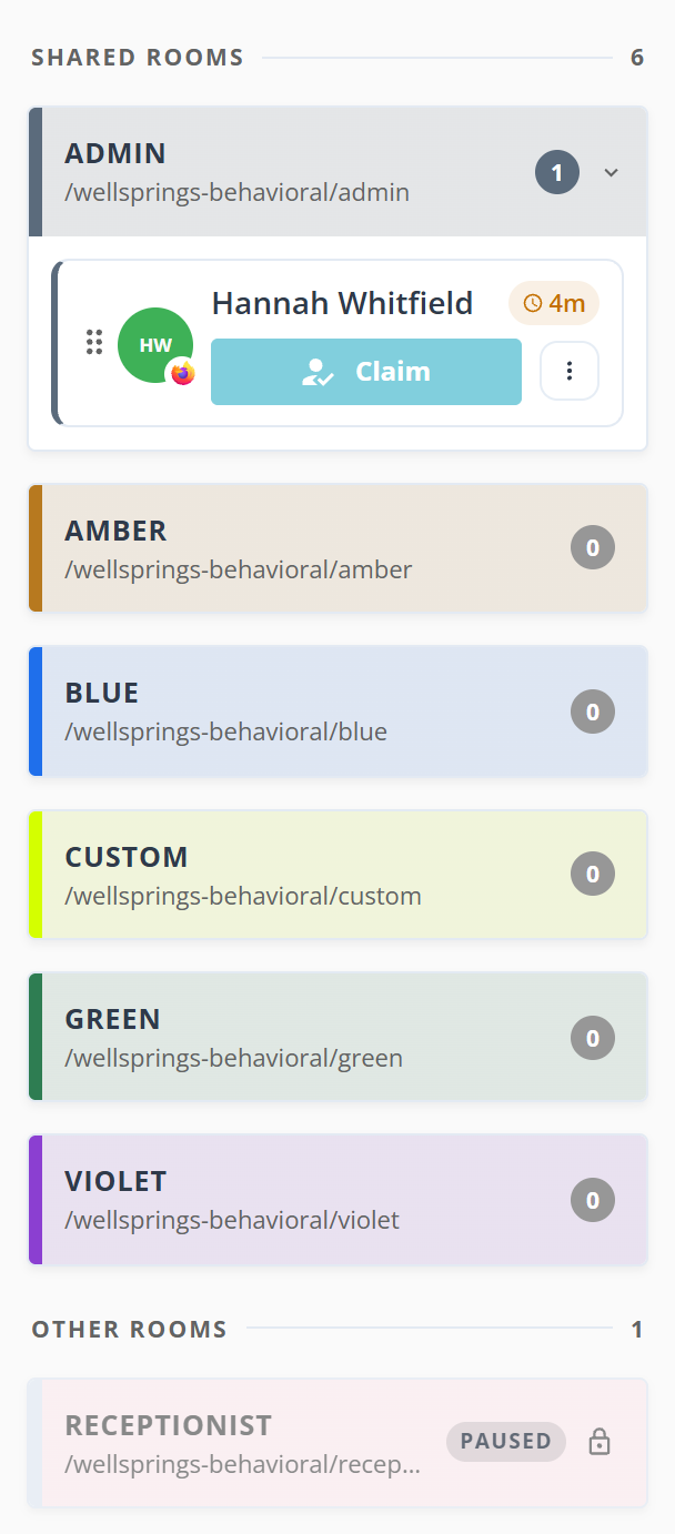 The shared rooms column of the dashboard. A SHARED ROOMS heading with a count of 6, then room cards: ADMIN holds a count of 1 and a card for Hannah Whitfield with a four minute wait pill, a Claim button and a three dot button. Amber, Blue, Custom, Green and Violet each show a count of 0. Below, an OTHER ROOMS heading with a count of 1 and a greyed Receptionist card carrying a PAUSED tag and a padlock.